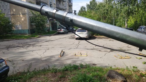 Мусоровоз зацепил электрический кабель, в результате чего произошло падение опоры освещения на автомобиль